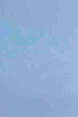 People gather at a makeshift memorial honoring victims outside Walmart, near the scene of a mass shooting which left at least 22 people dead, on August 15, 2019 in El Paso, Texas. Photo by Sandy Huffaker/Getty Images