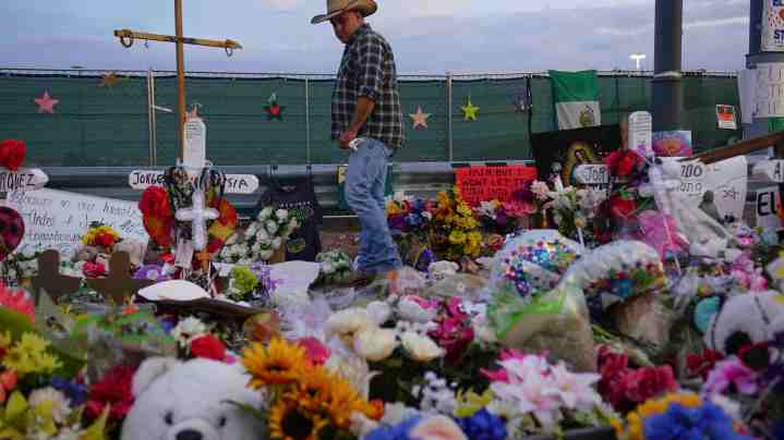 People gather at a makeshift memorial honoring victims outside Walmart, near the scene of a mass shooting which left at least 22 people dead, on August 15, 2019 in El Paso, Texas. Photo by Sandy Huffaker/Getty Images