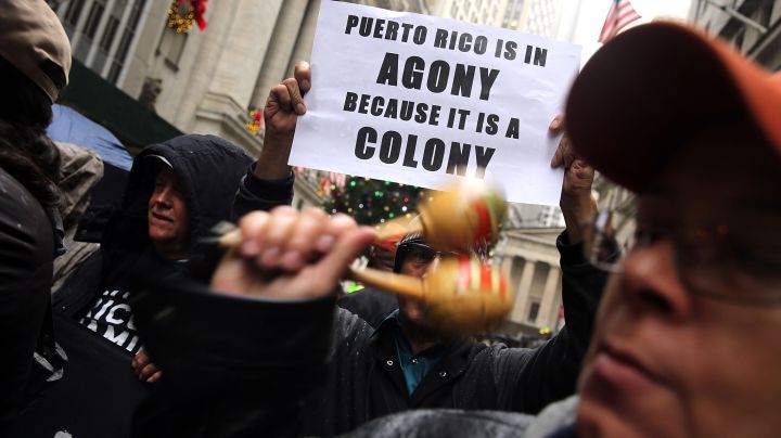 People protest outside of Wall Street against cutbacks and austerity measures forced onto the severely indebted island of Puerto Rico on December 2015. Photo by Spencer Platt/Getty Images