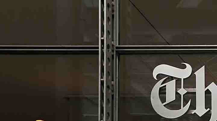 People walk past the New York Times building on July 27, 2017 in New York City. Photo by Spencer Platt/Getty Images