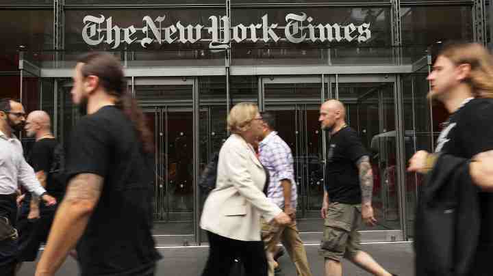 People walk past the New York Times building on July 27, 2017 in New York City. Photo by Spencer Platt/Getty Images