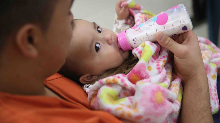 An immigrant detainee feeds his daughter during a family visitation visit at the Adelanto Detention Facility on November 15, 2013 in Adelanto, California. Photo by John Moore/Getty Images