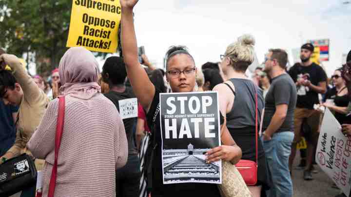 A woman raises her fist at the front of a march down Washington Avenue to protest racism and the violence over the weekend in Charlottesville, Virginia on August 14, 2017 in Minneapolis, Minnesota. Protesters estimated at more than 1,000 blocked streets and light rail during the action. Photo by Stephen Maturen/Getty Images