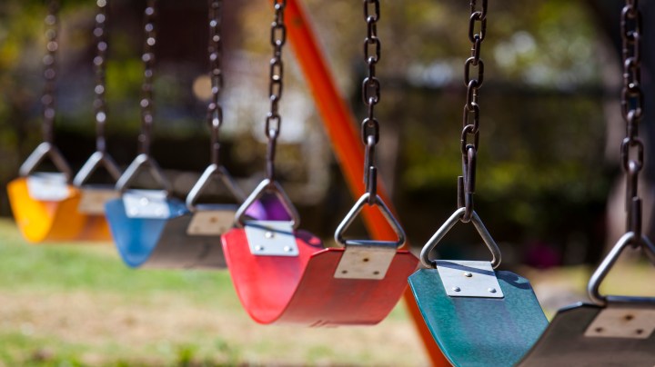 Empty colorful swings at the park. Getty Images
