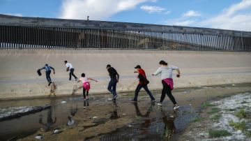 Migrants cross the border between the U.S. and Mexico at the Rio Grande river, as they enter El Paso, Texas on May 19, 2019. Photo by Mario Tama/Getty Images