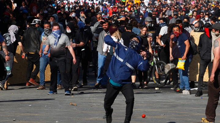 Anti-government demonstrators clash with police as they protest against cost of living increases on October 20, 2019 in Santiago, Chile. Photo by Marcelo Hernandez/Getty Images