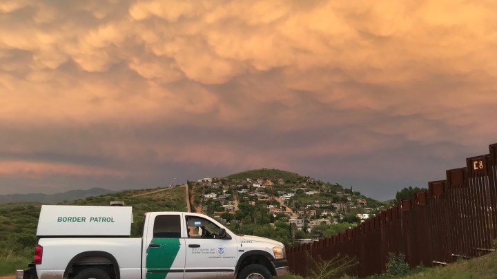 A U.S. Border Patrol agent watches over the U.S.-Mexico border at dusk on July 22, 2018 in Nogales, Arizona. Photo by John Moore/Getty Images