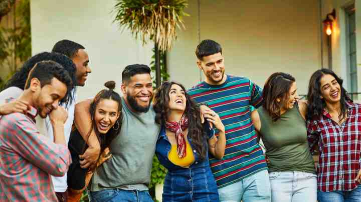 Friends enjoying a backyard garden party in Miami. Morsa Images / Getty Images