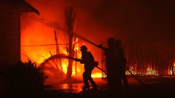 Firefighters battle the Kincade Fire as it burns a barn on October 27, 2019 in Santa Rosa, California. Photo by Justin Sullivan/Getty Images