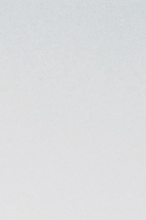 Grid fence with barbed wire against sunset. Getty Images