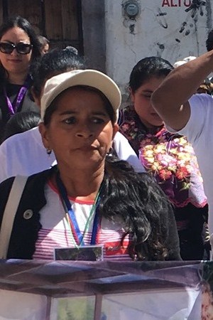 Women carrying the photos of their disappeared loved ones while on the Caravan of Mothers of Missing Migrants in Mexico. Photo by Barbara Sostaita
