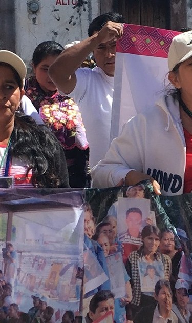 Women carrying the photos of their disappeared loved ones while on the Caravan of Mothers of Missing Migrants in Mexico. Photo by Barbara Sostaita