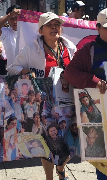 Women carrying the photos of their disappeared loved ones while on the Caravan of Mothers of Missing Migrants in Mexico. Photo by Barbara Sostaita