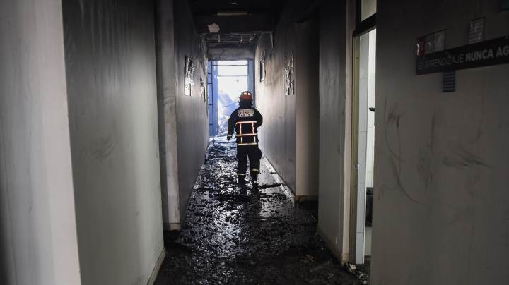 A firefighter inspects the damages made on Pedro de Valdivia university that was burned on November 8 during the protests against the government of President Sebastian Piñera on November 9, 2019 in Santiago, Chile. Photo by Claudio Santana/Getty Images