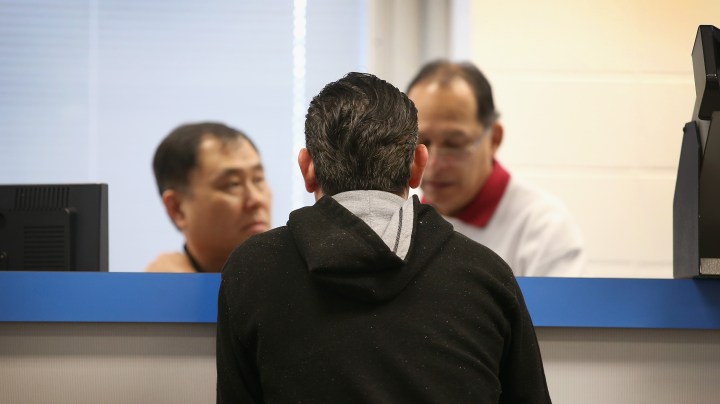 A Chicago man applies for a Temporary Visitors Driver's License at a driver services facility on December 10, 2013 in Chicago, Illinois. Photo by Scott Olson/Getty Images