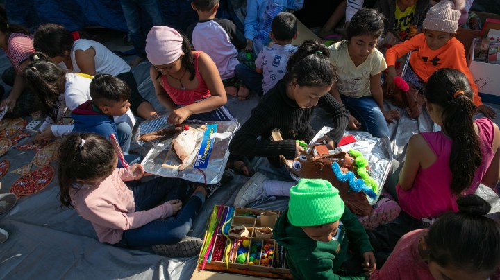 Immigrant children make Christmas decorations during class at "The Sidewalk School" at a camp for asylum seekers on December 08, 2019 in the Mexican border town of Matamoros, Mexico. Photo by John Moore/Getty Images