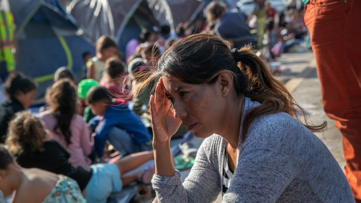 A mother sits as children take part in class at "The Sidewalk School" for immigrant children at a camp for asylum seekers on December 08, 2019 in the Mexican border town of Matamoros, Mexico. Photo by John Moore/Getty Images