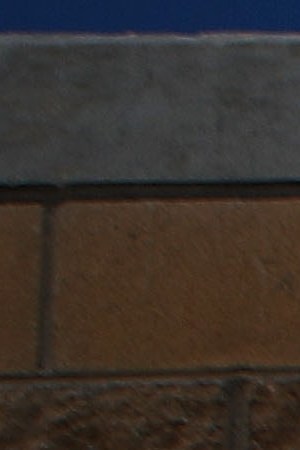 A woman stands at the El Chapparal port of entry, with a sign pointing toward the U.S., on January 25, 2019 in Tijuana, Mexico. Photo by Mario Tama/Getty Images