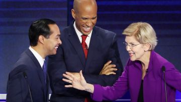 Former housing secretary Julian Castro, Sen. Cory Booker (D-NJ) and Sen. Elizabeth Warren (D-MA) react during the first night of the Democratic presidential debate on June 26, 2019 in Miami, Florida. Photo by Raedle/Getty Images