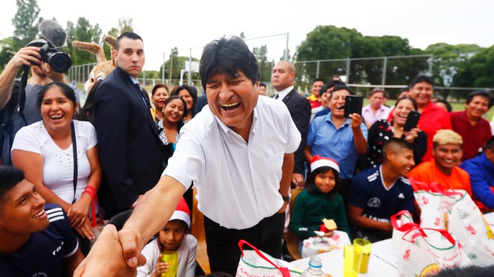 Exiled former president of Bolivia Evo Morales laughs as he shakes hands during a Christmas breakfast with members of the Bolivian community of Buenos Aires at Campo De Deportes del Colegio Nacional de Buenos Aires on December 25, 2019 in Buenos Aires, Argentina. Photo by Marcos Brindicci/Getty Images