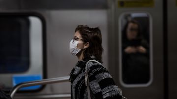 A woman wears a protective mask as walking on the subway on February 27, 2020 in São Paulo, Brazil. Photo by Victor Moriyama/Getty Images