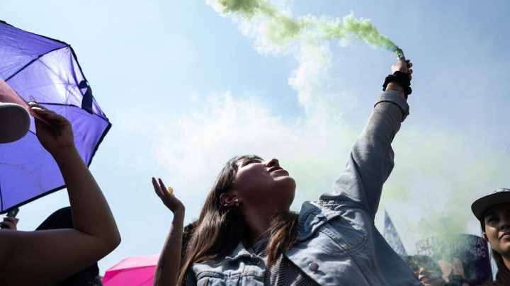 A demonstrator lights a flare during a rally on International Women's Day on March 8, 2020 in Mexico City, Mexico. Photo by Toya Sarno Jordan/Getty Images