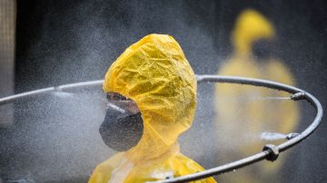 A participant gets his suit sanitized after taking part of a course that prepared military personnel from all over the state on the combat of the coronavirus (COVID-19) on April 9, 2020 in Belo Horizonte, Brazil. Photo by Pedro Vilela/Getty Images