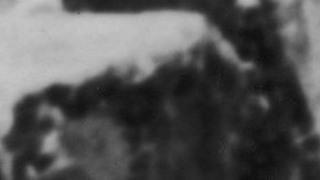 Three Peruvian Indians stand in traditional dress on a masonry ledge of the ancient Incan city of Machu Picchu and look out over a deep valley at one of the Amazon's source streams, early 20th Century. Photo by Henry Clay Gipson/Frederic Lewis/Getty Images