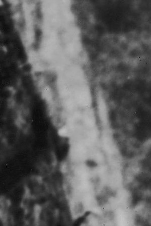 Three Peruvian Indians stand in traditional dress on a masonry ledge of the ancient Incan city of Machu Picchu and look out over a deep valley at one of the Amazon's source streams, early 20th Century. Photo by Henry Clay Gipson/Frederic Lewis/Getty Images