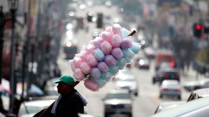A street vendor carries cotton candy on February 16, 2017 in Los Angeles, California. Photo by Justin Sullivan/Getty Images
