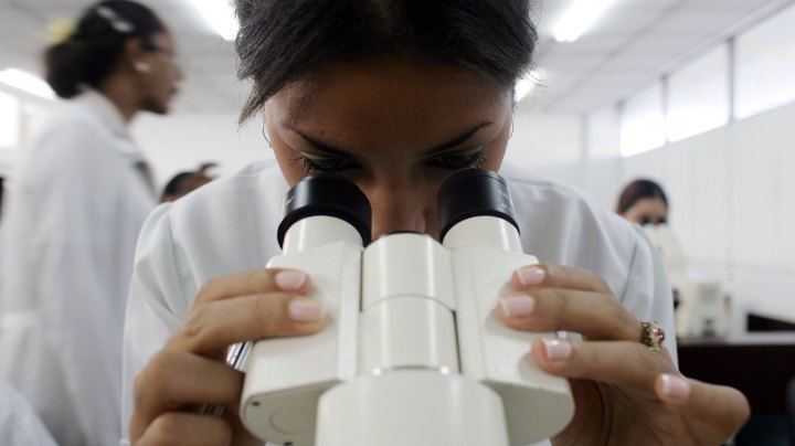 Marielys Krystel Dominguez Guerra from Panama looks through a microscope during a class while attending the Latin American School of Medical Sciences December 4, 2006 in Havana, Cuba. Photo by Joe Raedle/Getty Images