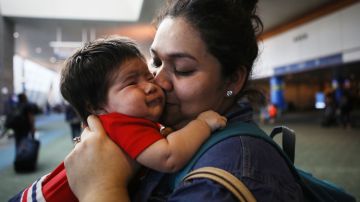 An immigrant who identified herself only as Vioney (R), recently released after spending six months in an ICE detention facility, holds her grandson Mateo for the first time while being reunited with family members at Portland International Airport on September 2, 2018 in Portland, Oregon. Photo by Mario Tama/Getty Images