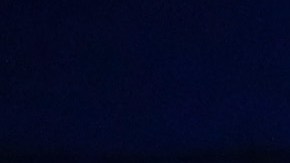 Activist Angel Ulloa (L) holds a candle at a vigil outside the Border Patrol station where lawyers reported that detained migrant children were held unbathed and hungry on June 25, 2019 in Clint, Texas. Photo by Mario Tama/Getty Images