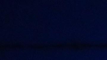 Activist Angel Ulloa (L) holds a candle at a vigil outside the Border Patrol station where lawyers reported that detained migrant children were held unbathed and hungry on June 25, 2019 in Clint, Texas. Photo by Mario Tama/Getty Images