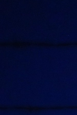 Activist Angel Ulloa (L) holds a candle at a vigil outside the Border Patrol station where lawyers reported that detained migrant children were held unbathed and hungry on June 25, 2019 in Clint, Texas. Photo by Mario Tama/Getty Images