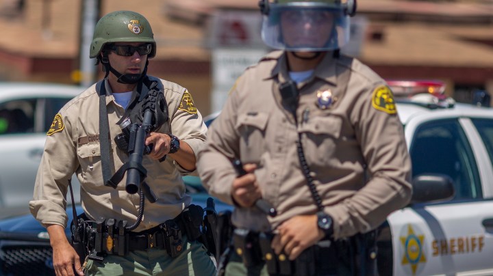 \Sheriffs block marchers from continuing down E. Palmdale Boulevard (State Route 138) after a demonstration on June 13, 2020 in Palmdale, California. The marchers were leaving a demonstration at a tree where authorities say Robert Fuller, a 24-year-old black man, was found dead, hanging from a tree, near Palmdale City Hall. Photo by David McNew/Getty Images