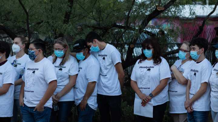 Community members and family wear shirts that read "Nana Ayudame or Nana, help me" in Spanish at a vigil for Carlos Adrián Ingram-Lopez on June 25, 2020 in Tucson, Arizona. Photo by Caitlin O'Hara/Getty Images