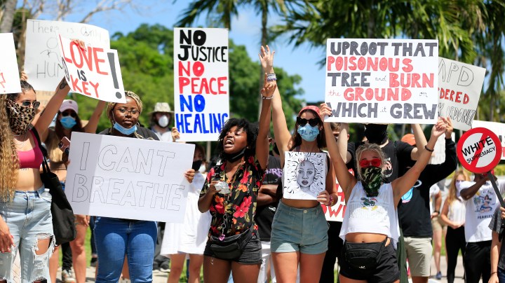 MIAMI, FLORIDA - MAY 30: Activists hold a rally in response to the recent death of George Floyd at the Torch of Friendship in Bayfront Park on May 30, 2020 in Miami, Florida. Miami joins protest after the police killing of George Floyd. Four Minneapolis police officers have been fired after a video taken by a bystander was posted on social media showing Floyd's neck being pinned to the ground by an officer as he repeatedly said, "I can’t breathe". Floyd was later pronounced dead while in police custody after being transported to Hennepin County Medical Center. (Photo by Cliff Hawkins/Getty Images)