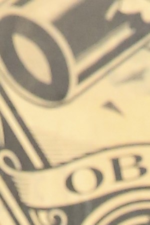 Artist Tony Peralta poses for a portrait in front of Shepard Fairey's artwork at The Dean Collection X BACARDI No Commission Art Fair.  Photo by Monica Schipper/Getty Images for Bacardi