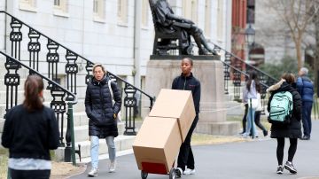 Sophomore Sadia Demby moves her belongings through Harvard Yard on the campus of Harvard University on March 12, 2020 in Cambridge, Massachusetts. Photo by Maddie Meyer/Getty Images