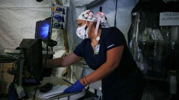 A nurse works in a makeshift tent triage center for patients suspected of being COVID-19 positive outside El Centro Regional Medical Center in hard-hit Imperial County on July 21, 2020 in El Centro, California. Photo by Mario Tama/Getty Images