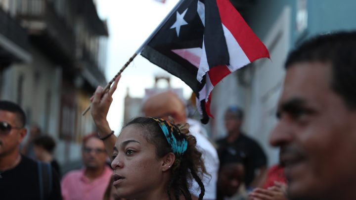 Protesters demonstrate against Ricardo Rossello, the Governor of Puerto Rico, near police that are manning a barricade set up along a street leading to the governor's mansion on July 23, 2019 in Old San Juan, Puerto Rico. Photo by Joe Raedle/Getty Images