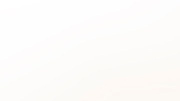 Cropped hand wearing a nitrile glove holding a COVID-19 vaccine vial and a syringe. Getty Images