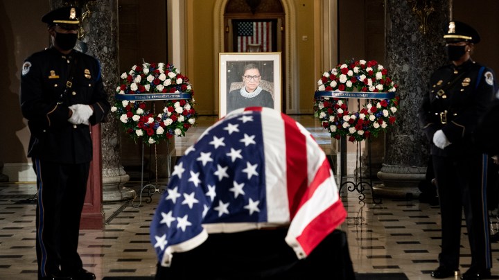The flag-draped casket of the late Associate Justice Ruth Bader Ginsburg lies in state in Statuary Hall of the US Capitol during a memorial service in her honor on September 25, 2020 in Washington, DC. Photo by Erin Schaff-Pool/Getty Images