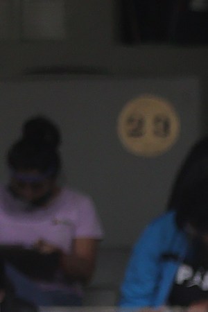 A staff member stands guard among students who take their UNAM admission exam while following the preventive measuress to avoid Covid-19 at Olimpico Universitario Stadium on August 19, 2020 in Mexico City, Mexico. Photo by Hector Vivas/Getty Images