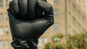 Attorney Ben Crump raises his fist in the air with a woman on September 15, 2020 in Louisville, Kentucky. Photo by Brandon Bell/Getty Images