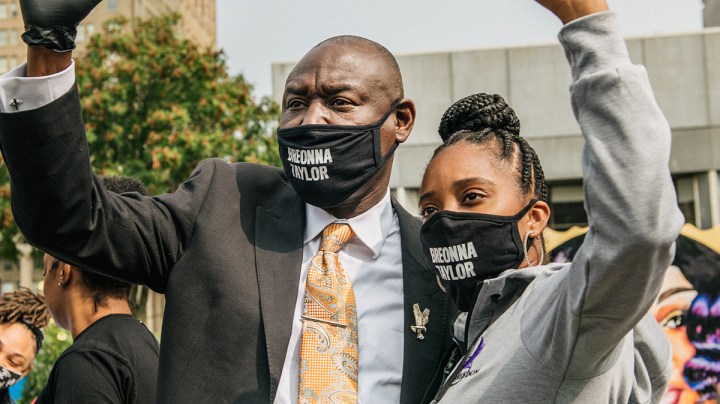 Attorney Ben Crump raises his fist in the air with a woman on September 15, 2020 in Louisville, Kentucky. Photo by Brandon Bell/Getty Images