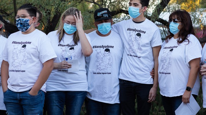 Community members and family wear shirts that read "Nana Ayudame or Nana, help me" in Spanish at a vigil for Carlos Adrián Ingram Lopez on June 25, 2020 in Tucson, Arizona. Photo by Caitlin O'Hara/Getty Images