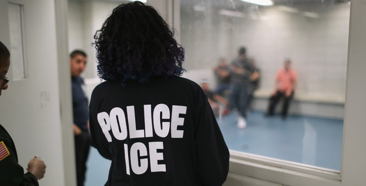 Undocumented immigrants wait in a holding cell at a U.S. Photo by John Moore/Getty Images