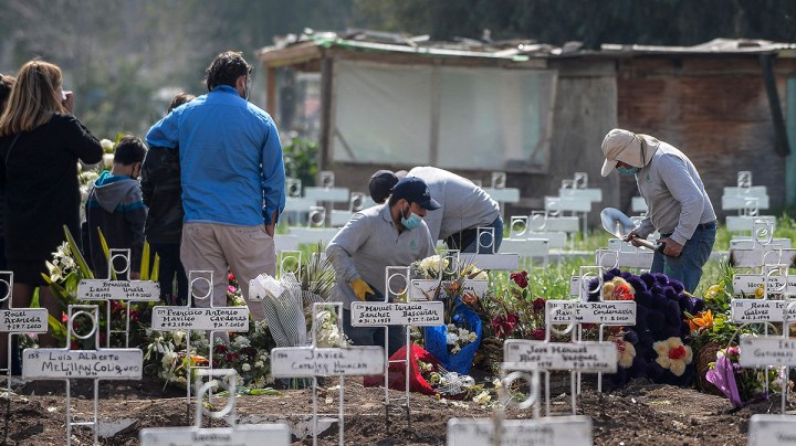 Family members of a person who died of COVID-19 attend a funeral at Cementerio General on September 4, 2020 in Santiago, Chile. Photo by Claudio Santana/Getty Images